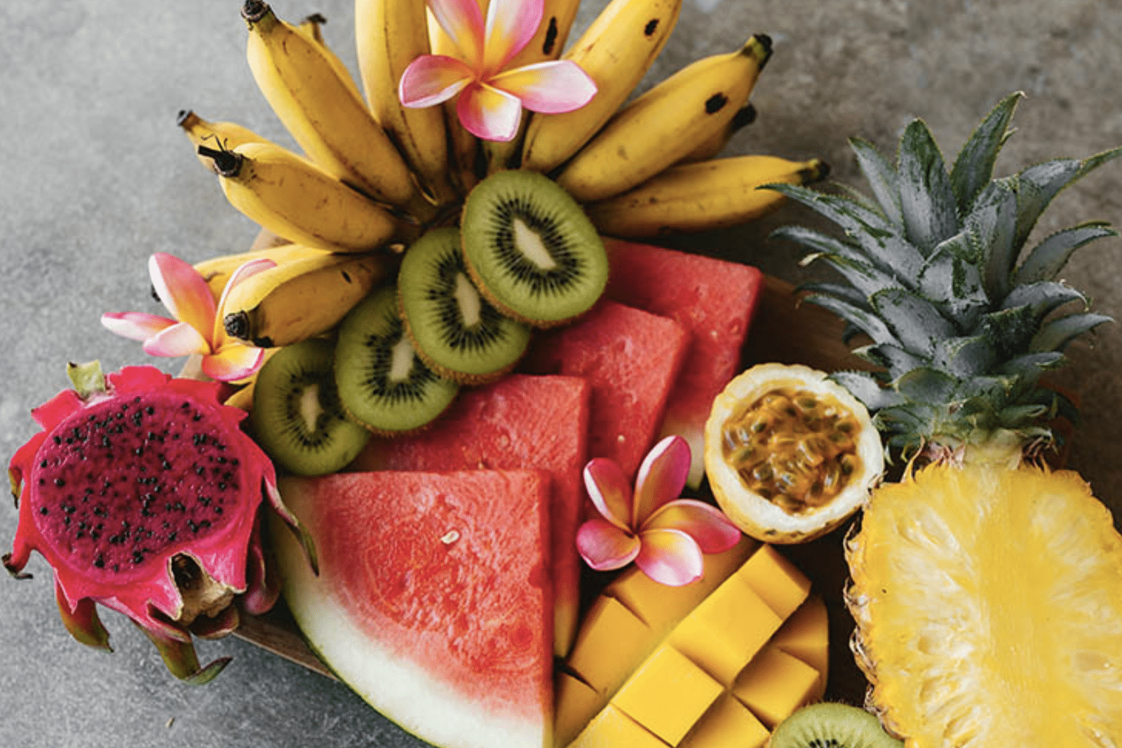 Delicious fresh fruit laid out on a stone board for guests of Upstate Studios Bali retreat to enjoy.